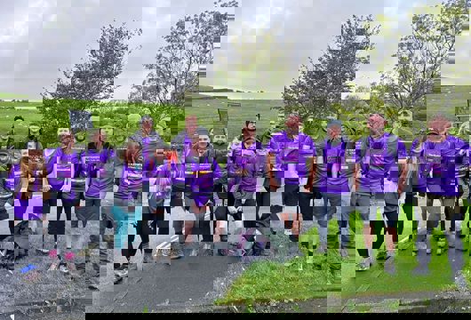 A group photo of 13 Yorkshire Housing colleagues about to take on Yorkshire 3 Peaks