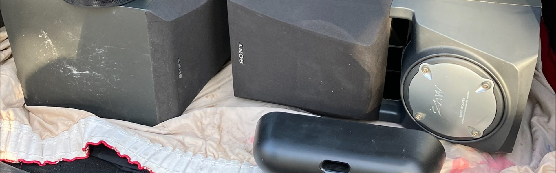 Audio equipment including two large speakers in the open boot of a car