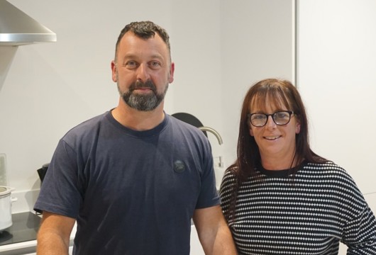 Yorkshire Housing customers Liz and Paul stood in the kitchen of their new home at the Climate Innovation District in Leeds.