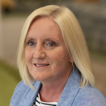 Woman smiling at camera in office environment 