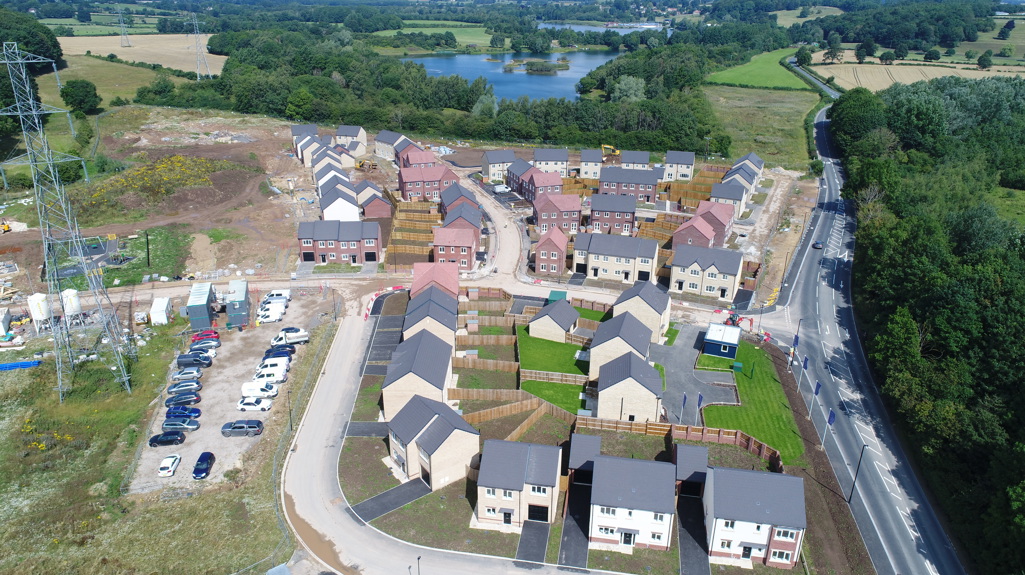 Houses being built on a development with a lake in the background