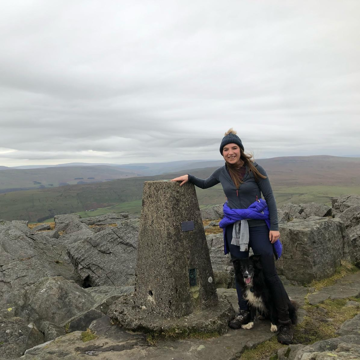 Sian climbing with her dog, reaching the peak! 