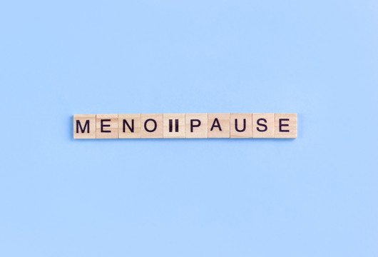 Scrabble wooden letters spelling the word menopause