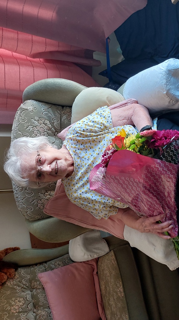 Dorothy sat in a chair with her flowers